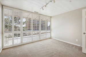 Carpeted bedroom with south facing balcony