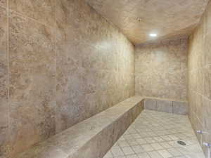 Full bath with recessed lighting, a relaxing sauna, and a tile shower