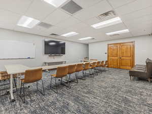 Office area with a paneled ceiling