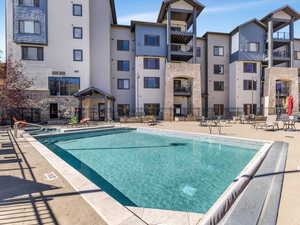 Community pool with a patio