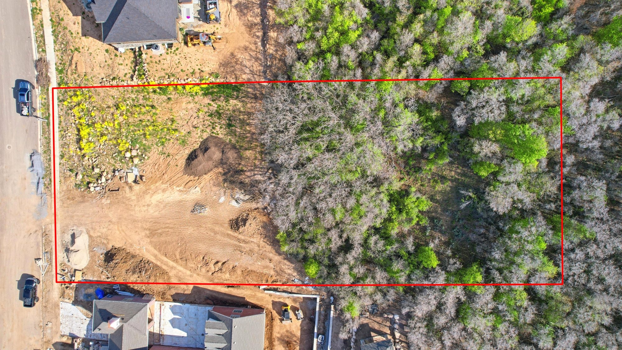 Expansive rectangular lot featuring a cleared building area and mature treeline