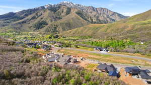 Expansive mountainous terrain surrounding a developing residential area