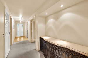 Hallway with carpet flooring and recessed lighting