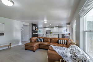 Living room with light colored carpet and recessed lighting