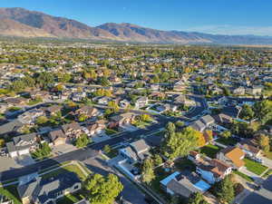 Aerial overview of property's location featuring mountains and nearby suburban area