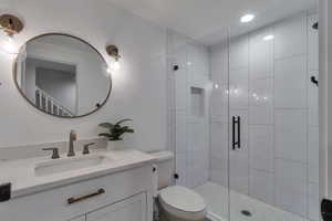 Full bathroom with a stall shower and vanity
