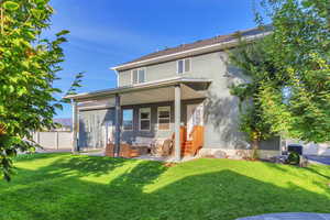 Rear view of property featuring a patio area, stucco siding, and an outdoor living space