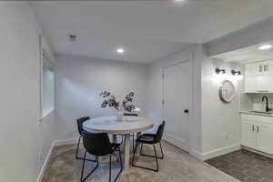 Dining area featuring recessed lighting, dark colored carpet, and dark tile patterned floors