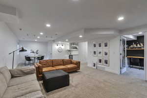Living area featuring recessed lighting, carpet floors, and an office area