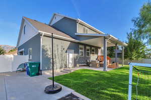 Back of house featuring a patio, a shingled roof, and stucco siding
