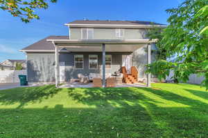 Back of property with a patio area, an outdoor living space, and stucco siding