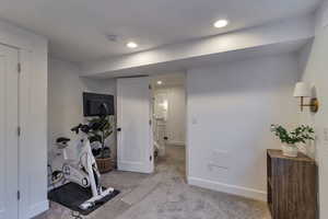 Exercise area with carpet floors and recessed lighting