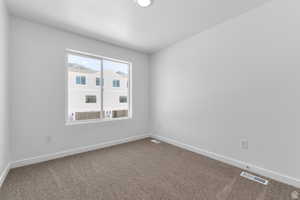 Carpeted empty room featuring baseboards