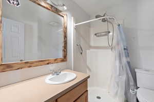 Bathroom featuring vanity and a stall shower