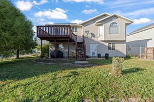 Rear view of property with a patio area, stairs, and a wooden deck