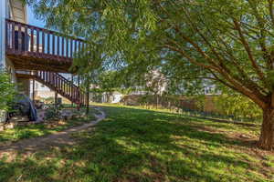 View of yard with a deck, stairway, and an outdoor structure