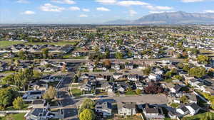 Aerial overview of property's location with nearby suburban area and mountains