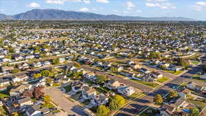 Aerial view of property's location with nearby suburban area and mountains