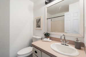 Bathroom featuring vanity and curtained shower