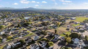 Aerial overview of property's location with nearby suburban area and a mountain backdrop