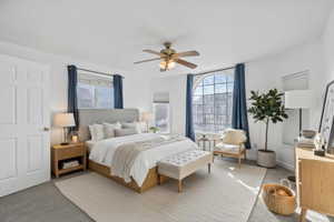 Carpeted bedroom with ceiling fan