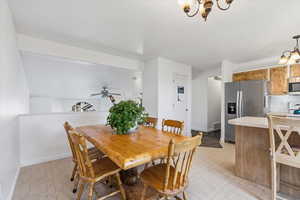 Dining room featuring a chandelier and light floors