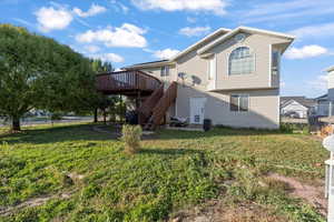 Rear view of property with stairs, a wooden deck, and a patio area
