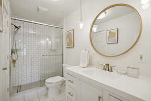 Bathroom featuring a stall shower, vanity, and a textured ceiling