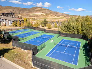 View of tennis court with a mountain view