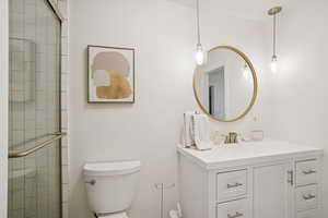 Bathroom featuring a stall shower and vanity