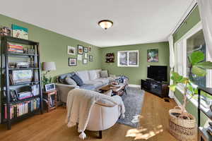 Living room featuring plenty of natural light and hardwood / wood-style floors
