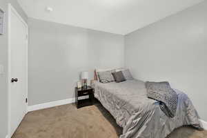 Carpeted bedroom with baseboards