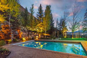 Pool at dusk with a patio