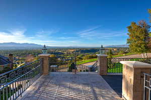 Wooden deck with a patio and a mountain view