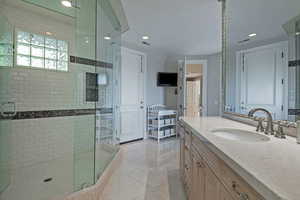 Full bathroom featuring vanity, a stall shower, and recessed lighting