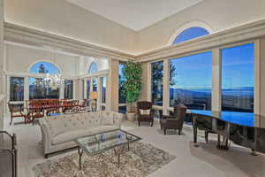 Sunroom with a chandelier and a high ceiling