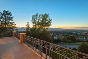 Balcony at dusk featuring a mountain view