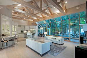 Building lobby featuring high vaulted ceiling, beamed ceiling, and expansive windows