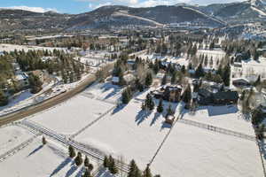 Snowy aerial view featuring a mountain view