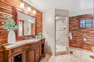 Full bathroom featuring vanity, a shower stall, and light tile patterned floors