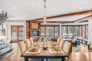 Dining space with beam ceiling, hardwood / wood-style floors, and recessed lighting