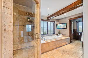 Bathroom with a shower stall, a garden tub, beam ceiling, and recessed lighting