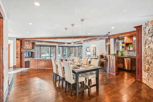Dining room featuring dark wood-type flooring and recessed lighting
