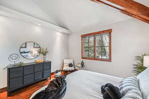 Bedroom featuring vaulted ceiling, wood finished floors, and recessed lighting