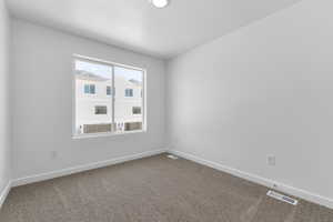 Empty room with carpet and baseboards
