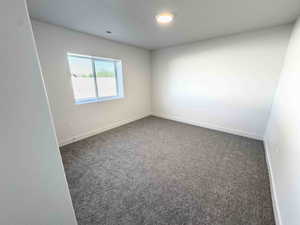 Unfurnished room with carpet flooring and baseboards