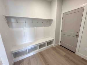 Mudroom with light wood finished floors and baseboards