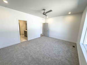 Unfurnished bedroom with light colored carpet, recessed lighting, ceiling fan, ensuite bathroom, and a textured ceiling
