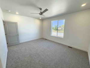 Carpeted spare room with recessed lighting, a textured ceiling, and ceiling fan