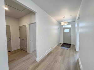Entryway with baseboards and light wood-style floors